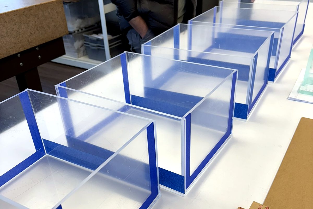 Production run of glued clear acrylic display boxes