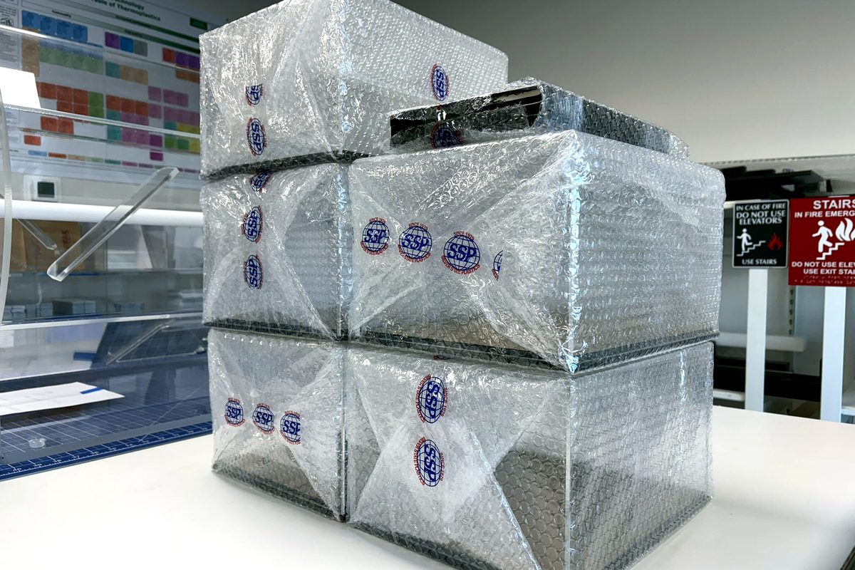 Finished acrylic boxes wrapped in Silver State Plastics branded bubble wrap