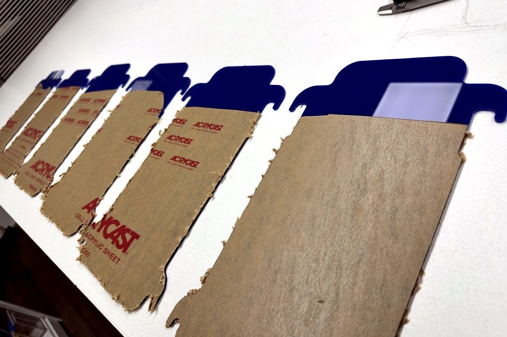 Laser-cut blue acrylic parts ready for line bending at Silver State Plastics in Sparks, NV