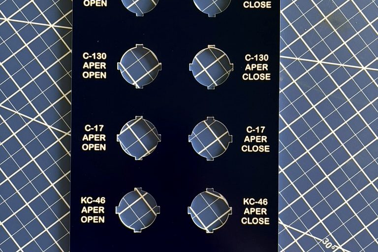 Laser-engraved industrial control panel legend plate with switch cutouts