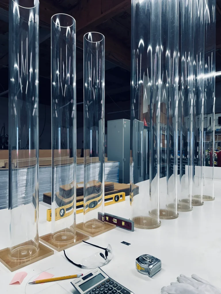 Transparent acrylic tubes on workshop table.