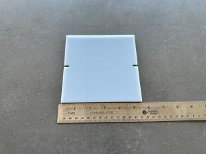 White tile with ruler for scale comparison